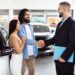 Seller checking documents before accepting cash for used car in Dubai