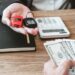 Customer receiving instant cash after selling a car in Dubai through a professional car buying service