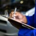 Professional home car inspection Dubai service assessing a vehicle